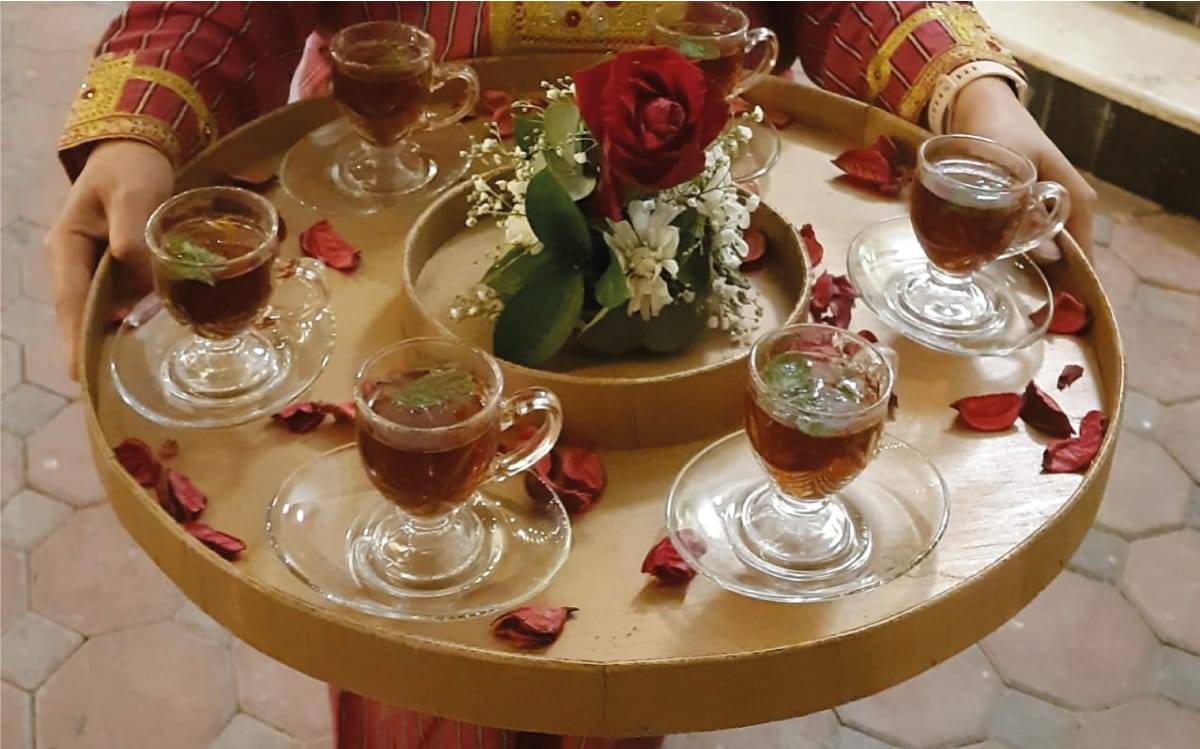 a group of glasses of tea on a table / Arabic coffee service shop