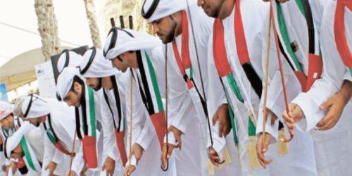 a group of men in white robes representing the Arabic culture