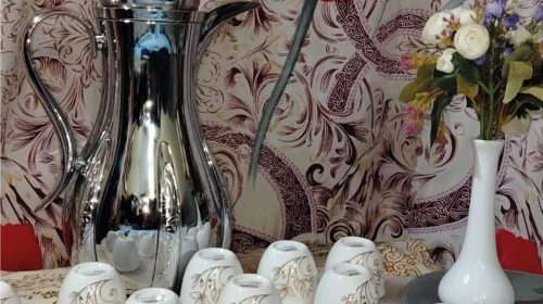 a group of cups and a vase of flowers at Arabic coffee service shop